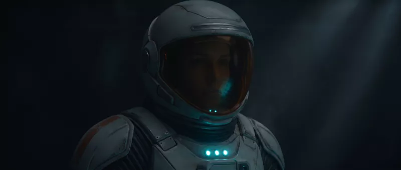The same shot with the lamp out, the face falling into shadow, only the chest indicators still lit.