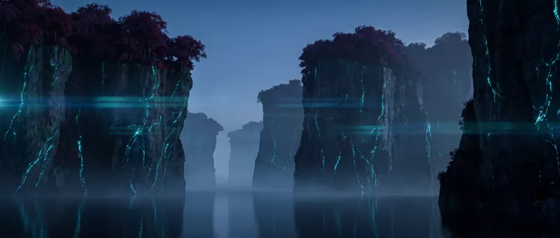 Cliffs rising from still misted water, dark red canopies on their crowns and turquoise veins running down the rock faces.